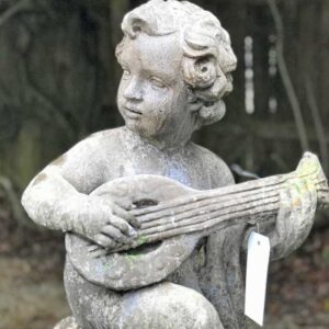 stone antique statue young child playing instrument