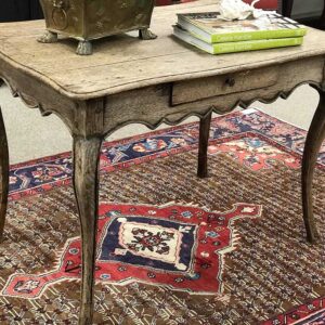 side table sitting on top of antique rug